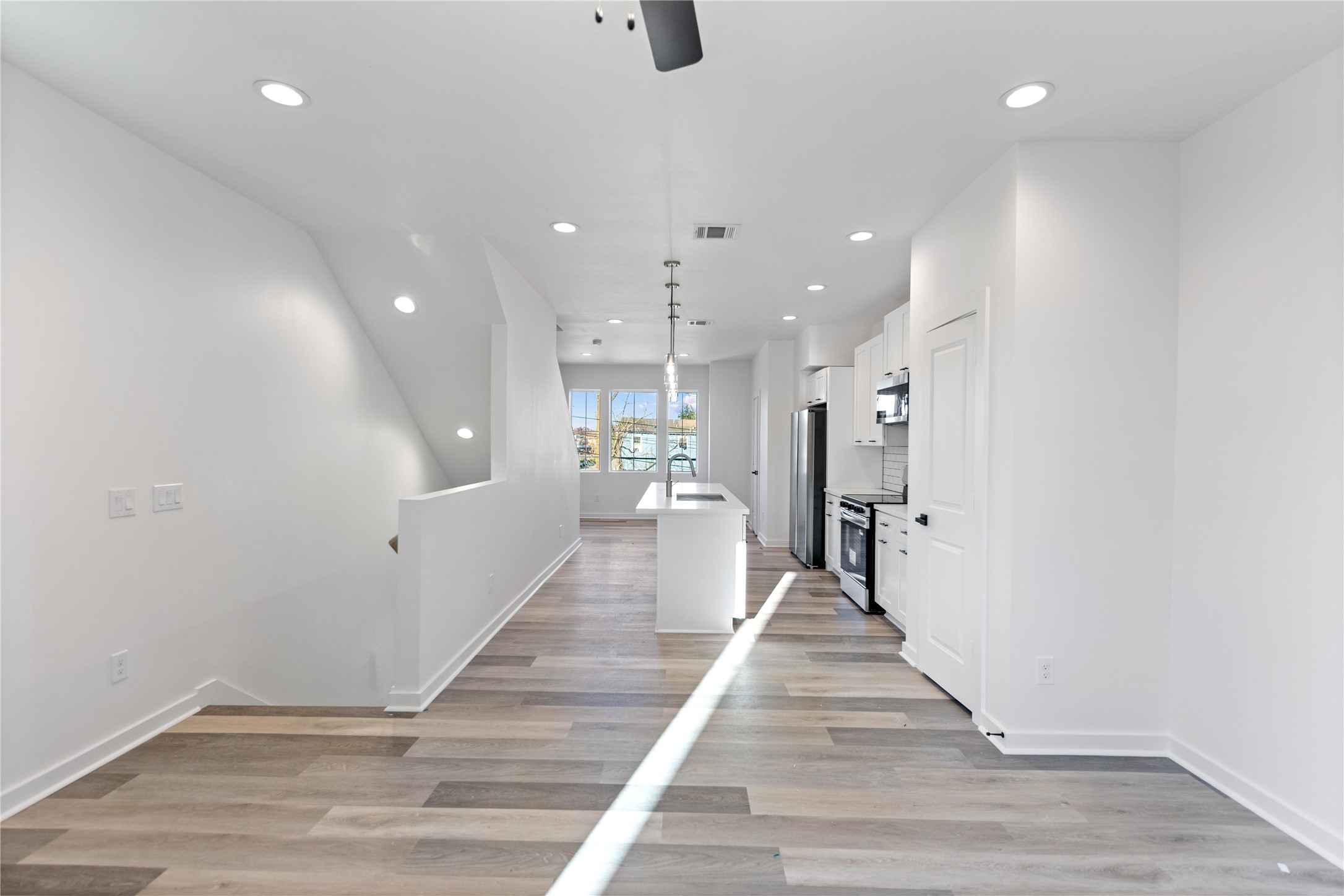 2702 Winbern Street, Unit A Houston, TX 77004 - Photo 14 of 16 a view of a hallway with wooden floor and staircase
