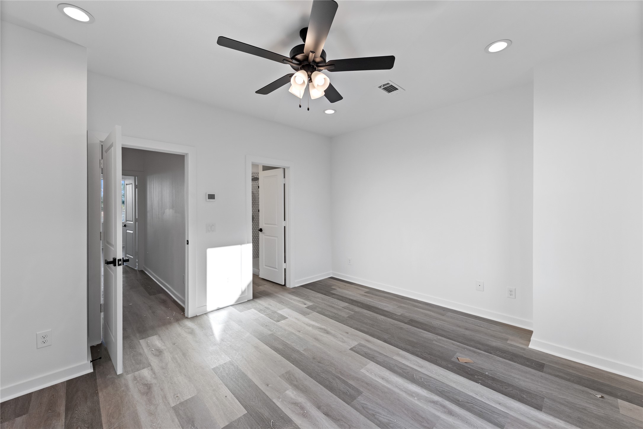 2702 Winbern Street, Unit A Houston, TX 77004 - Photo 2 of 16 wooden floor in an empty room with a window