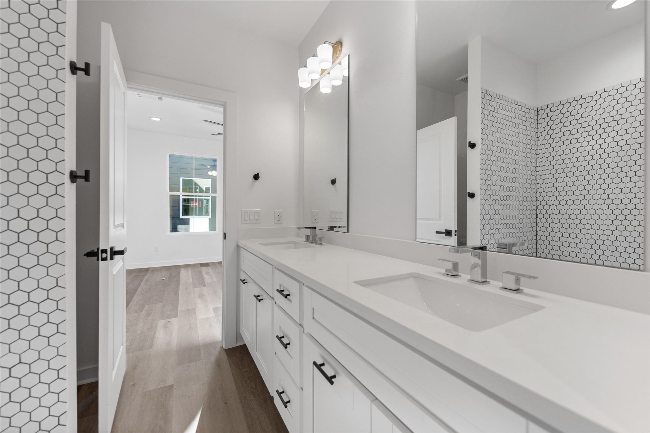 2702 Winbern Street, Unit A Houston, TX 77004 - Photo 6 of 16 a bathroom with double vanity sink and a mirror