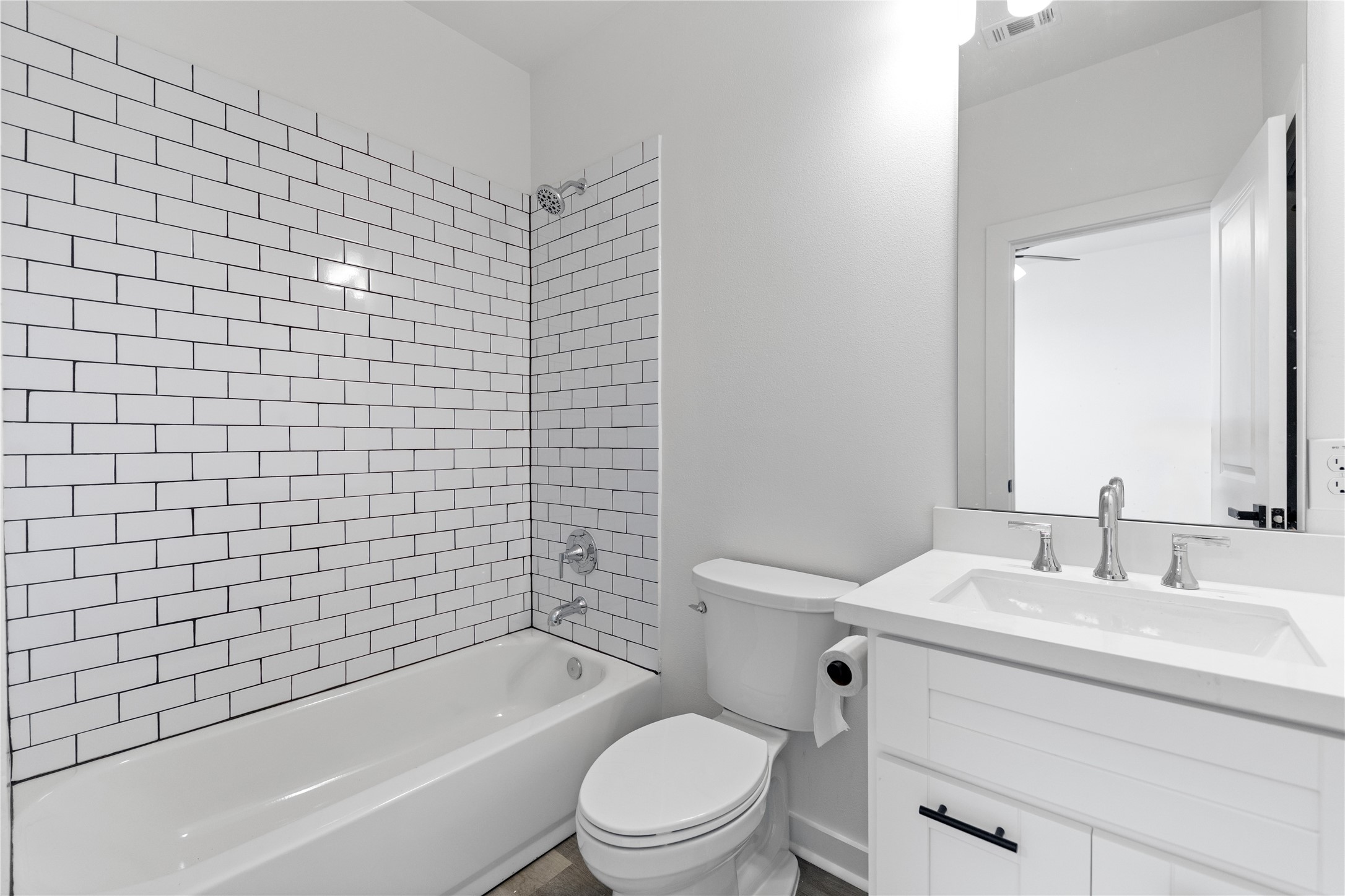 2702 Winbern Street, Unit A Houston, TX 77004 - Photo 9 of 16 a bathroom with a bathtub shower sink mirror vanity and toilet