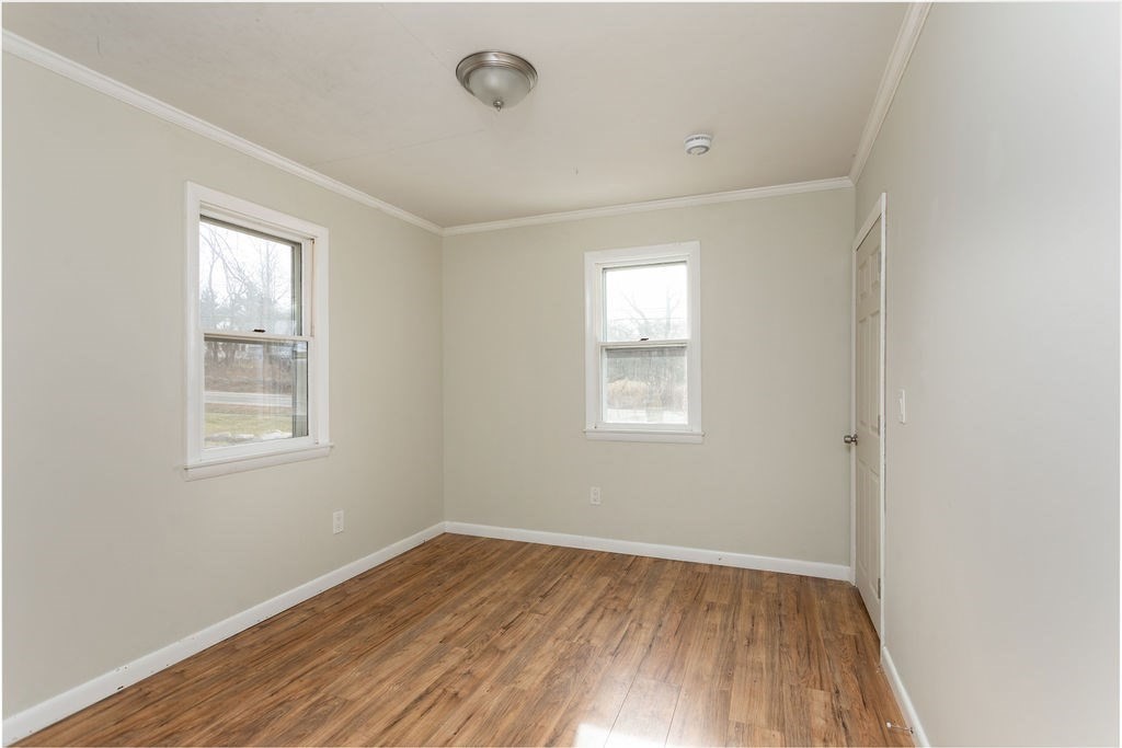 346 Amherst Road Pelham, MA 01002 - Photo 11 of 16 an empty room with wooden floor and windows