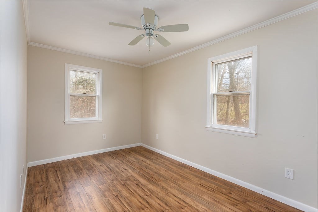 346 Amherst Road Pelham, MA 01002 - Photo 12 of 16 a view of an empty room with wooden floor and a window
