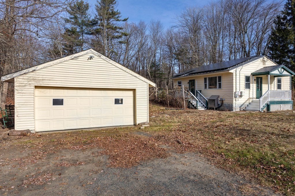 346 Amherst Road Pelham, MA 01002 - Photo 4 of 16 a view of a house with a small yard and large tree