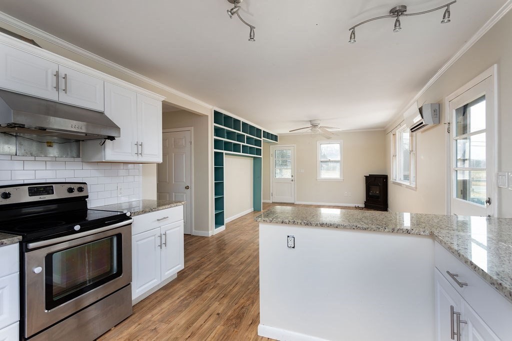 346 Amherst Road Pelham, MA 01002 - Photo 9 of 16 a kitchen with granite countertop a sink a stove and cabinets