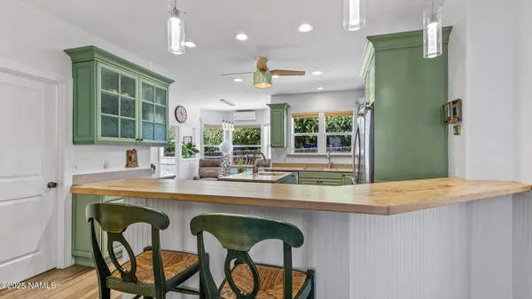 a kitchen with kitchen island a sink a counter top space stainless steel appliances and cabinets