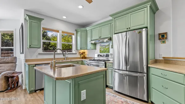 a kitchen with a sink a stove and a window