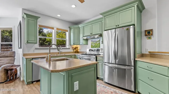 a kitchen with a sink a stove and a window