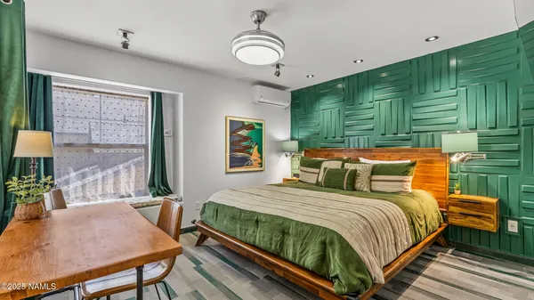 a bedroom with a bed and window