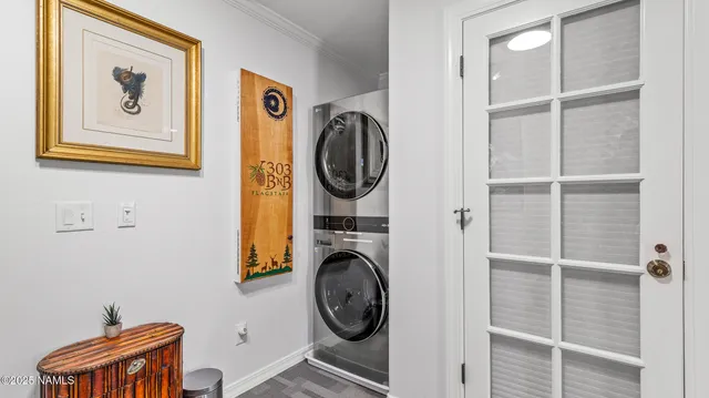 a living room with painting on the wall and a potted plant