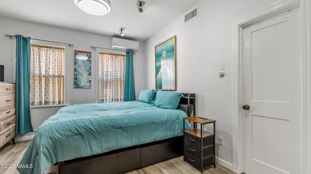a white bath tub sitting in a bathroom next to a window