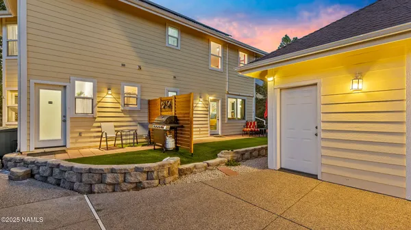 a view of a backyard with plants and a patio