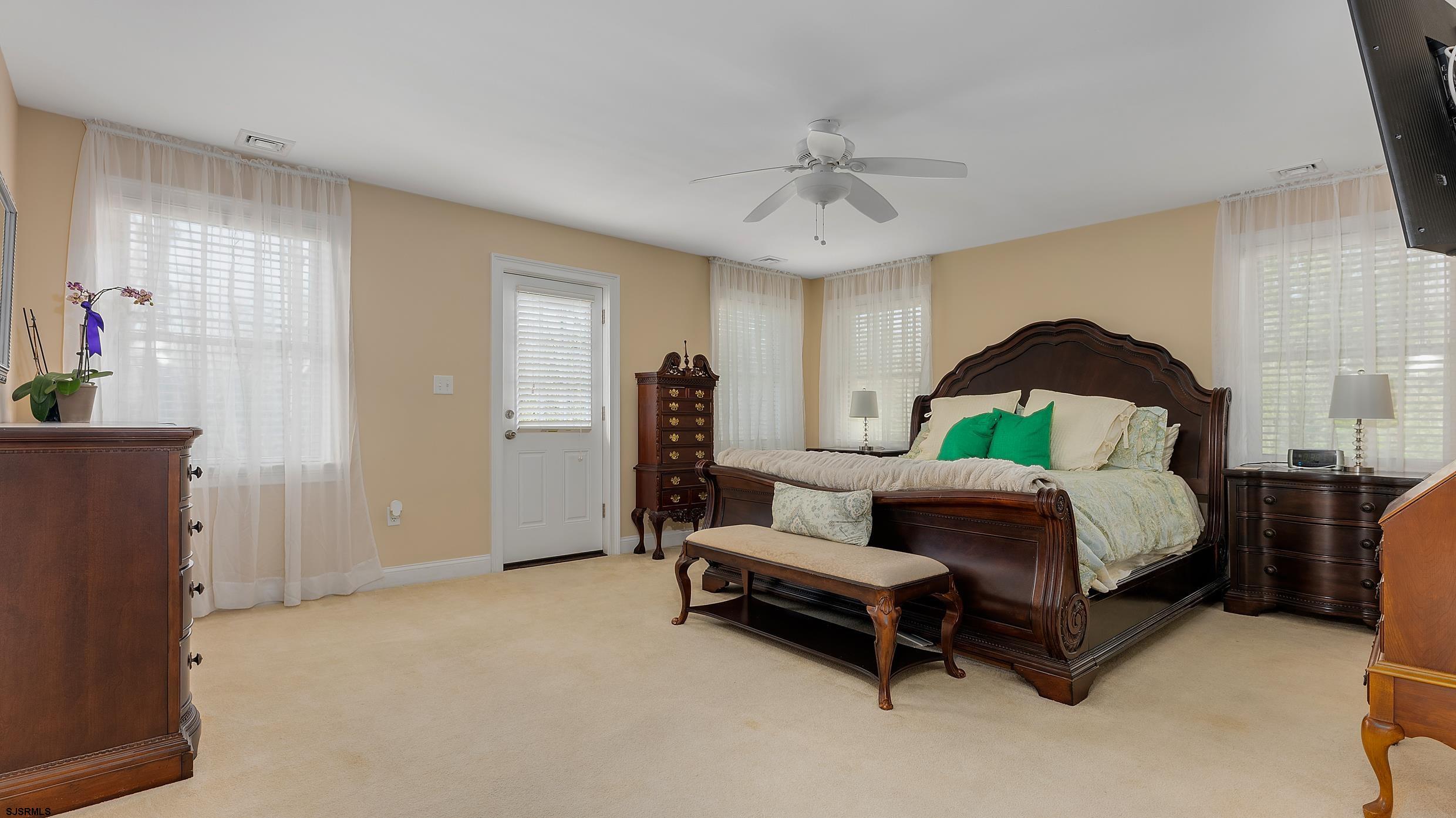 25 Brookside Drive Egg Harbor Township, NJ 08234 - Photo 14 of 47 a spacious bedroom with a bed and a chandelier