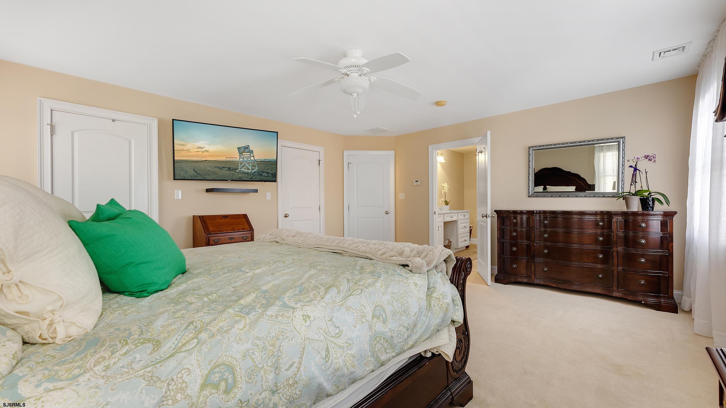 25 Brookside Drive Egg Harbor Township, NJ 08234 - Photo 19 of 47 a spacious bedroom with a bed a fireplace and a television
