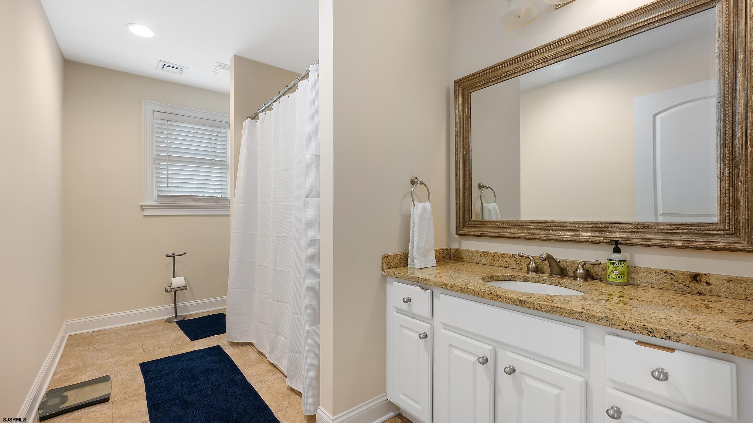 25 Brookside Drive Egg Harbor Township, NJ 08234 - Photo 27 of 47 a bathroom with a granite countertop sink and a mirror