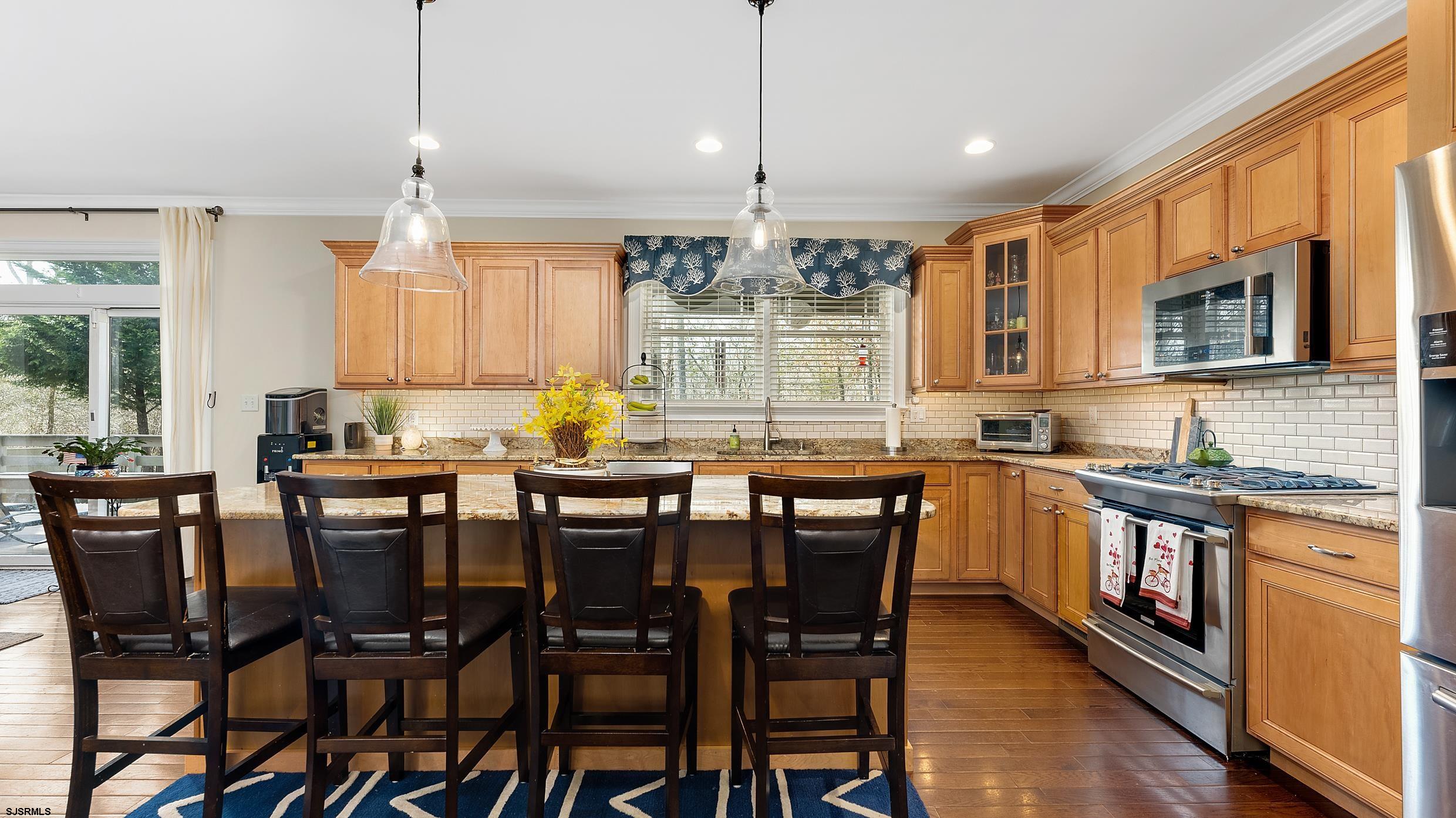 25 Brookside Drive Egg Harbor Township, NJ 08234 - Photo 3 of 47 a kitchen with stainless steel appliances granite countertop a stove top oven a sink a dining table and chairs