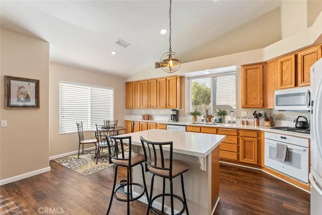 a large kitchen with a table and chairs