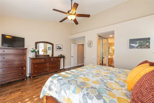 a bedroom with a bed and flat screen tv