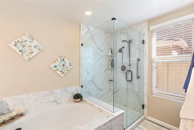 a bathroom with a bathtub and shower