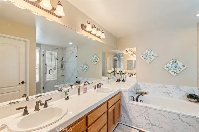 a bathroom with a bathtub a sink and a mirror