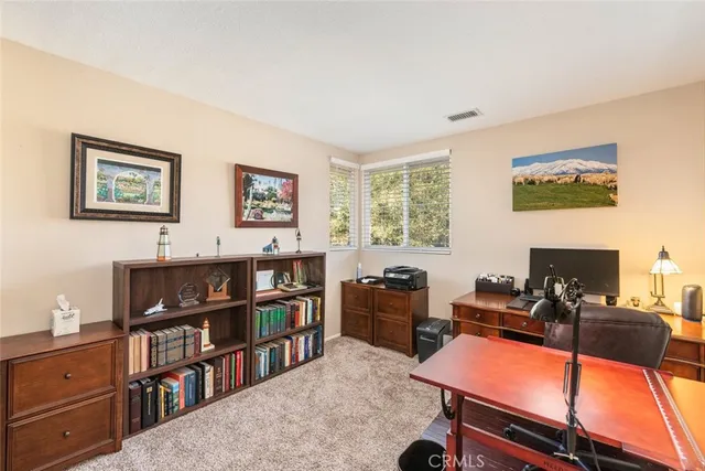 a room with furniture a bookshelf and a window