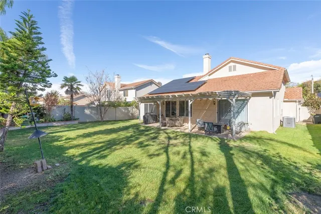 a backyard of a house with table and chairs