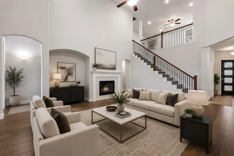 a living room with furniture fireplace and a potted plant