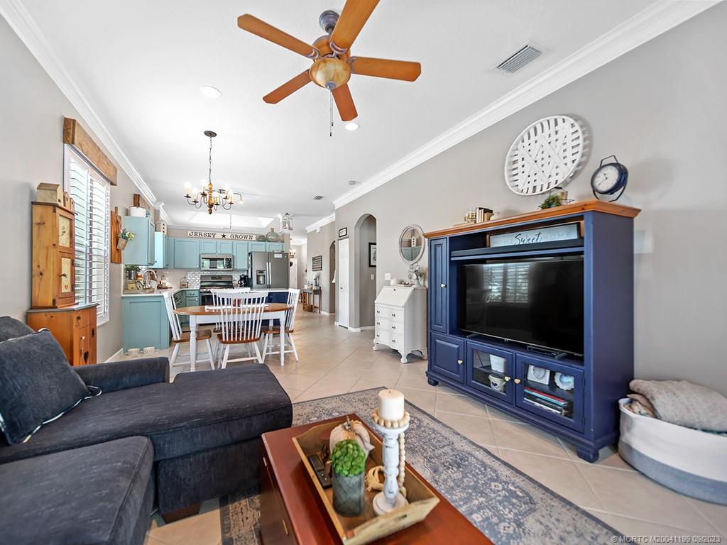 2498 Southeast Springtree Place Stuart, FL 34997 - Photo 11 of 25 a living room with furniture and a flat screen tv