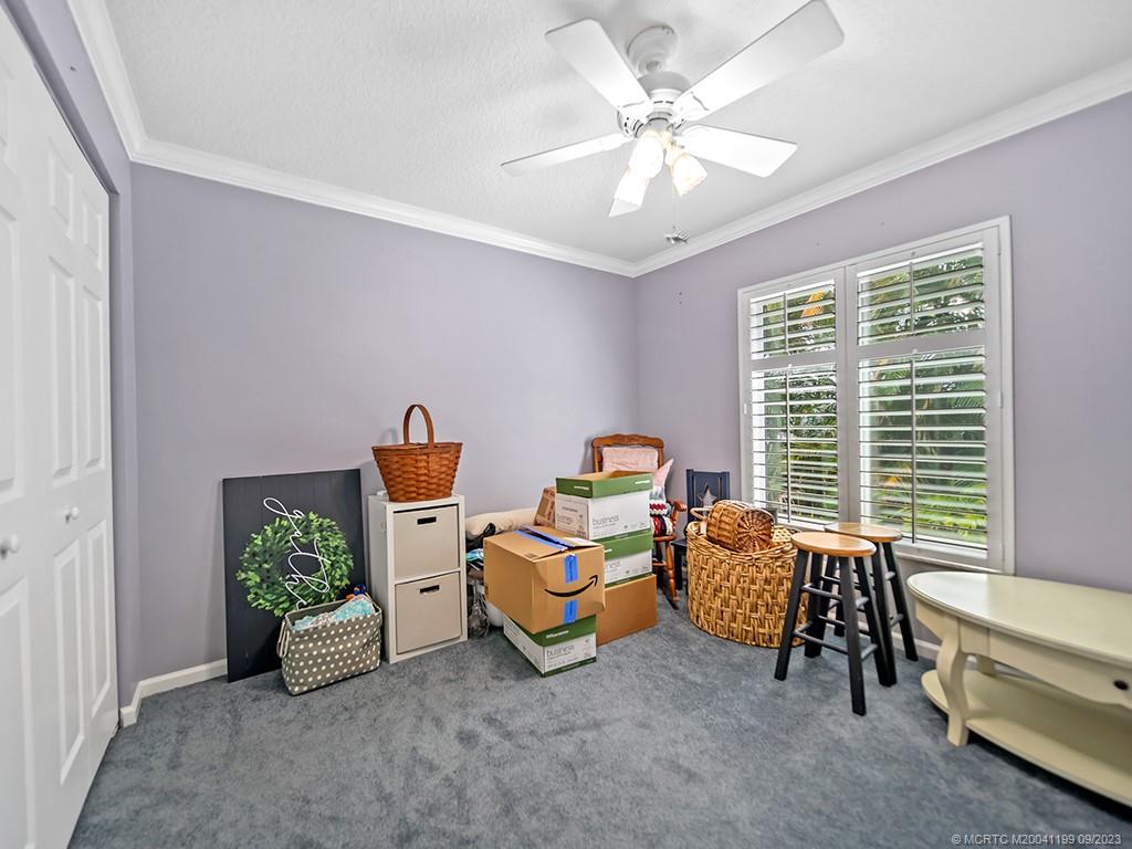 2498 Southeast Springtree Place Stuart, FL 34997 - Photo 12 of 25 a living room with furniture and a floor to ceiling window
