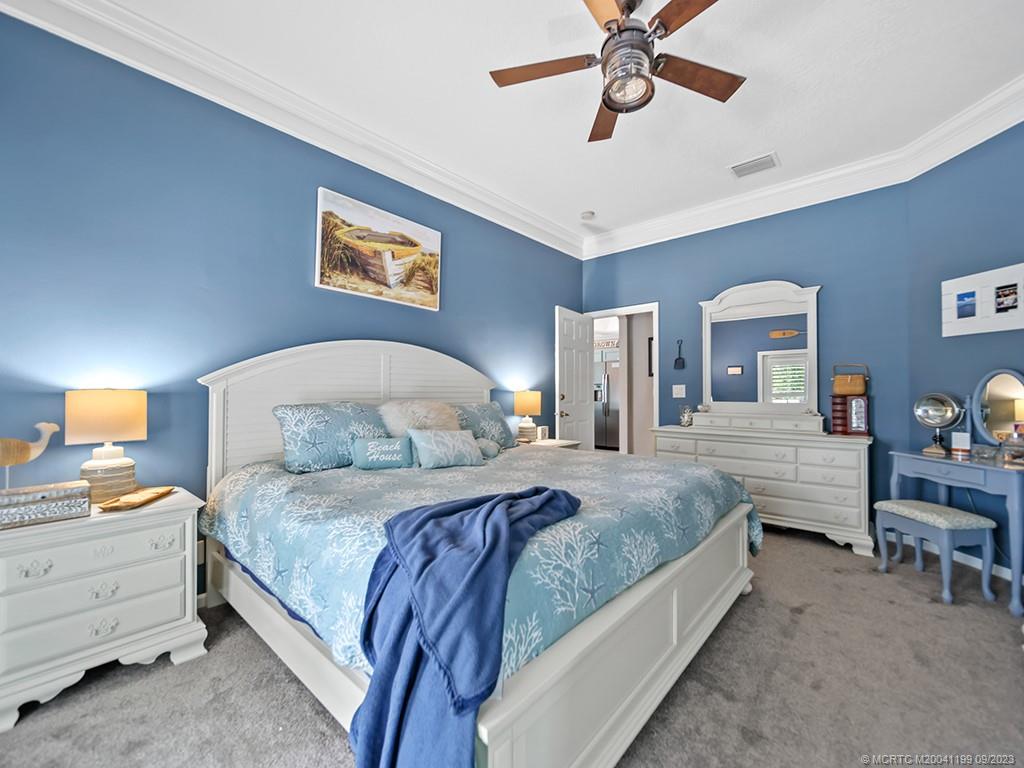 2498 Southeast Springtree Place Stuart, FL 34997 - Photo 16 of 25 a bedroom with bed and window