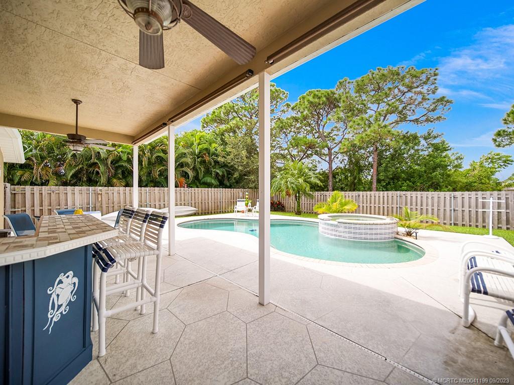 2498 Southeast Springtree Place Stuart, FL 34997 - Photo 18 of 25 a view of a swimming pool with a porch