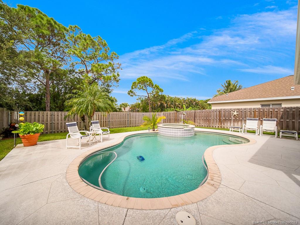 2498 Southeast Springtree Place Stuart, FL 34997 - Photo 21 of 25 a view of a swimming pool with a patio