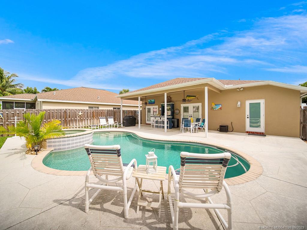 2498 Southeast Springtree Place Stuart, FL 34997 - Photo 22 of 25 a view of a house with swimming pool in front of it