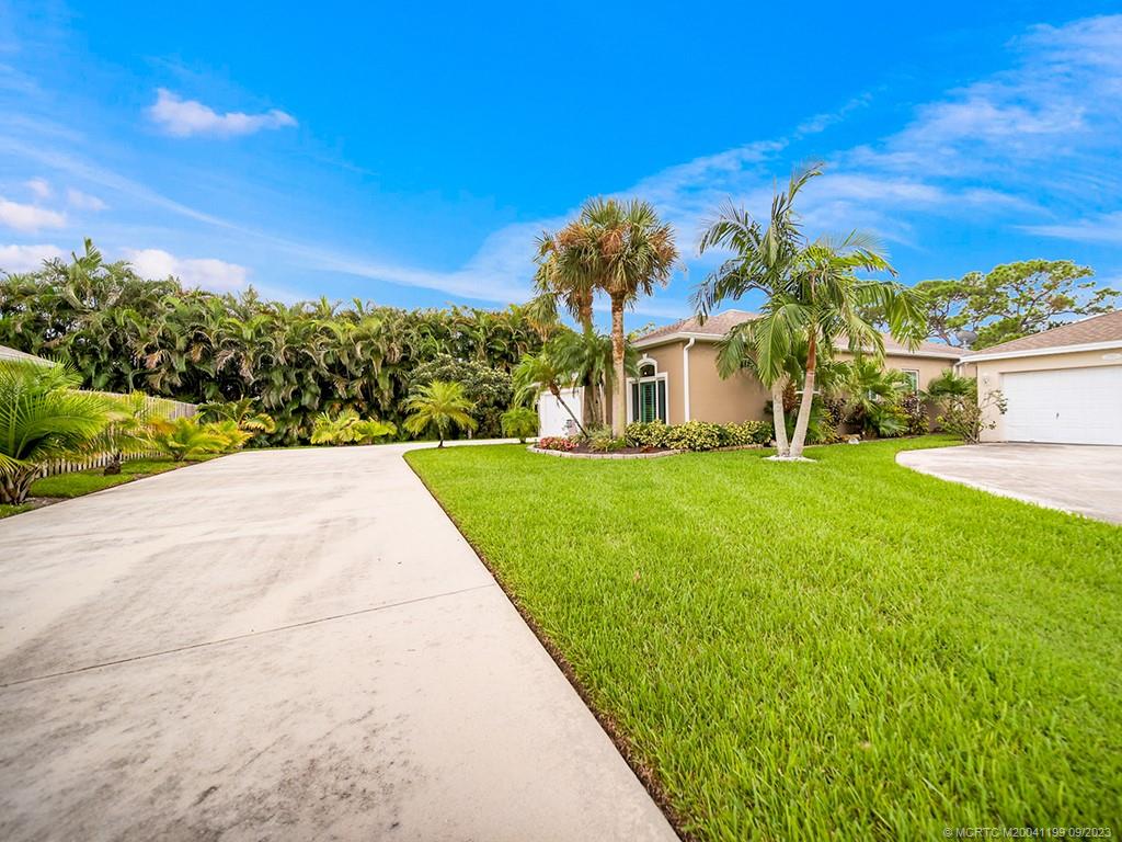 2498 Southeast Springtree Place Stuart, FL 34997 - Photo 23 of 25 a view of a house with a big yard