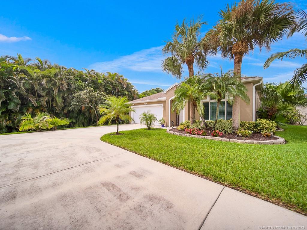2498 Southeast Springtree Place Stuart, FL 34997 - Photo 24 of 25 a view of a yard with palm tree