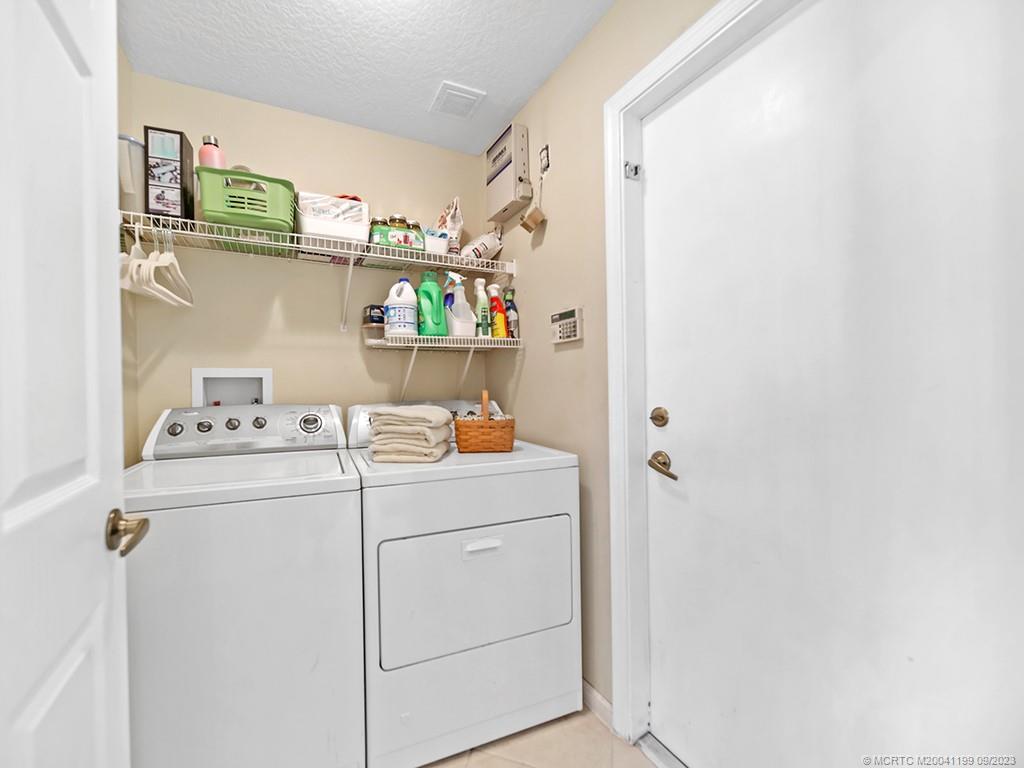 2498 Southeast Springtree Place Stuart, FL 34997 - Photo 25 of 25 a utility room with dryer and washer