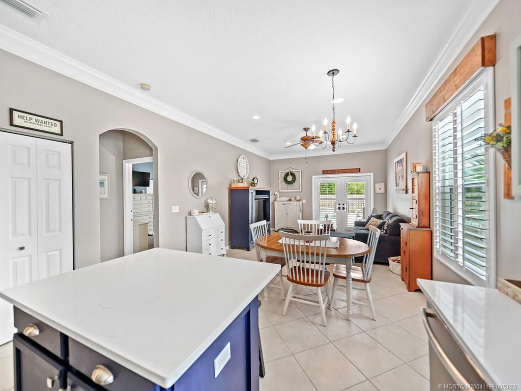 2498 Southeast Springtree Place Stuart, FL 34997 - Photo 9 of 25 a large living room with a large window