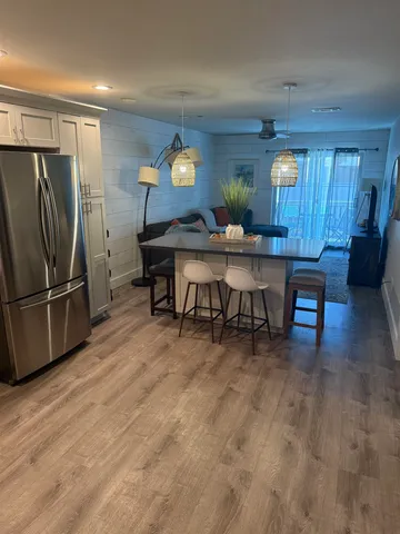 a kitchen with a sink a microwave a refrigerator and cabinets