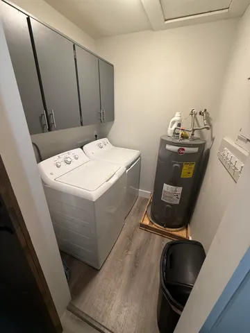 a bedroom with two beds and a chandelier