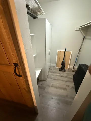 a large bed sitting in a bedroom next to a window and a flat screen tv