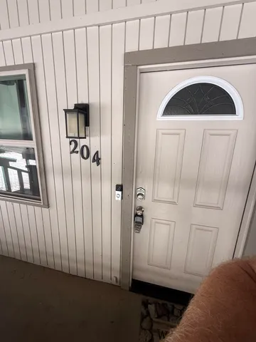a balcony with wooden floor table and chairs