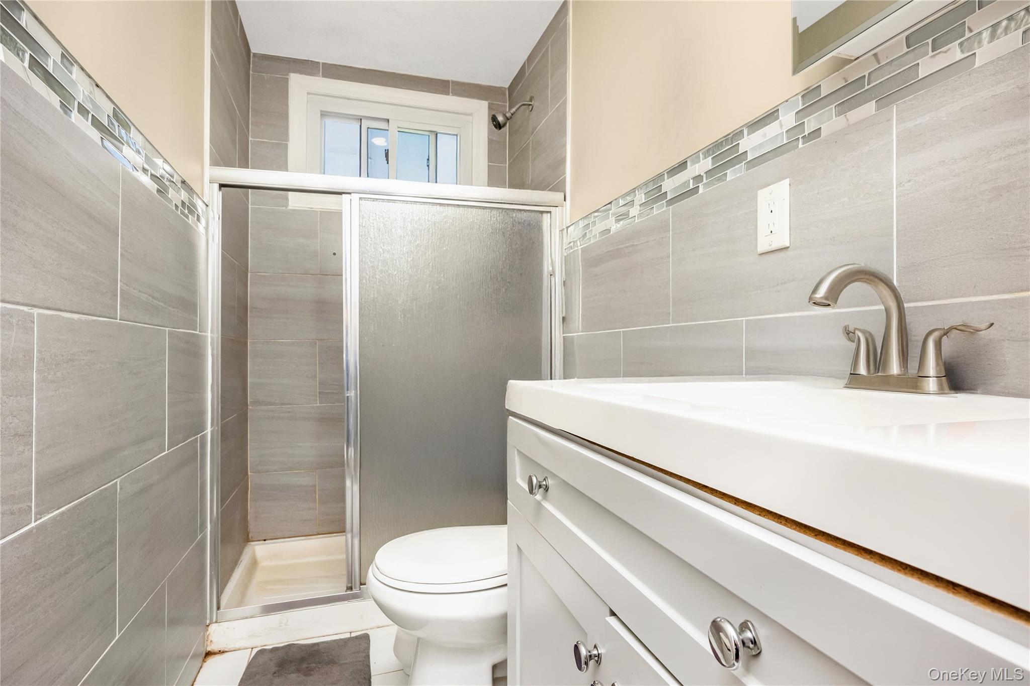 102-18 216th Street Queens, NY 11429 - Photo 9 of 23 a bathroom with a sink a toilet and shower