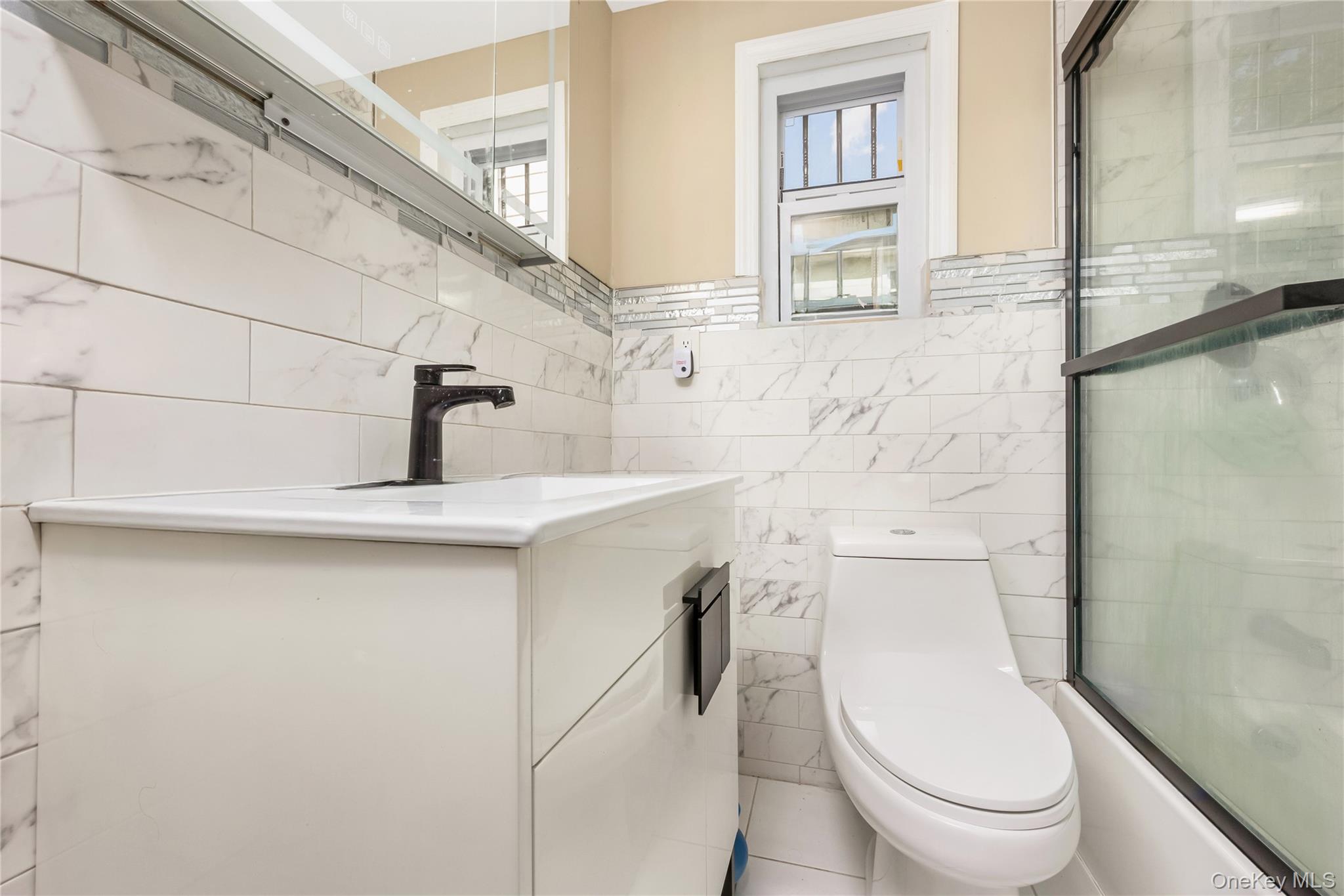 102-18 216th Street Queens, NY 11429 - Photo 10 of 23 a bathroom with a toilet sink and a mirror