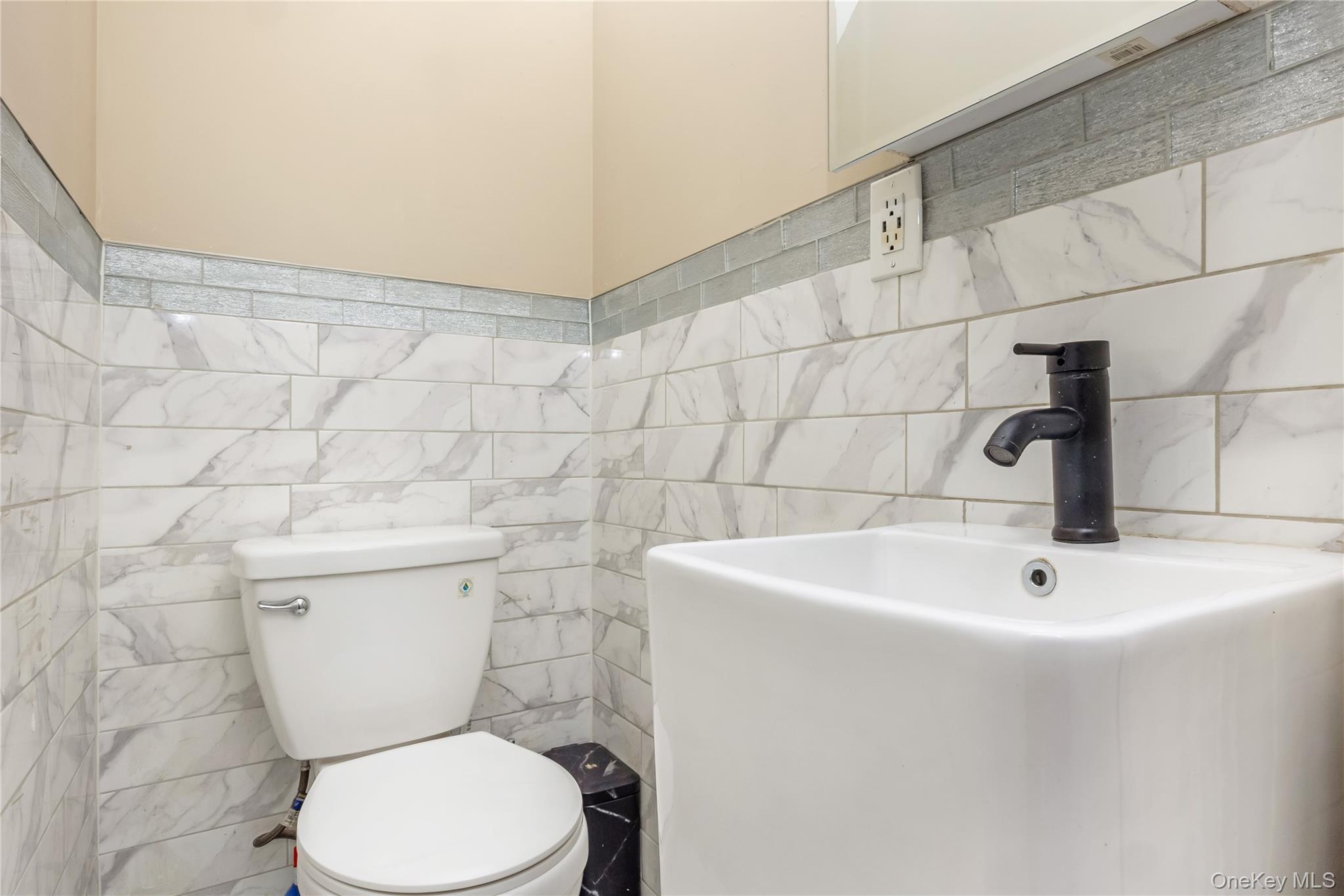 102-18 216th Street Queens, NY 11429 - Photo 11 of 23 a white toilet sitting next to a white sink