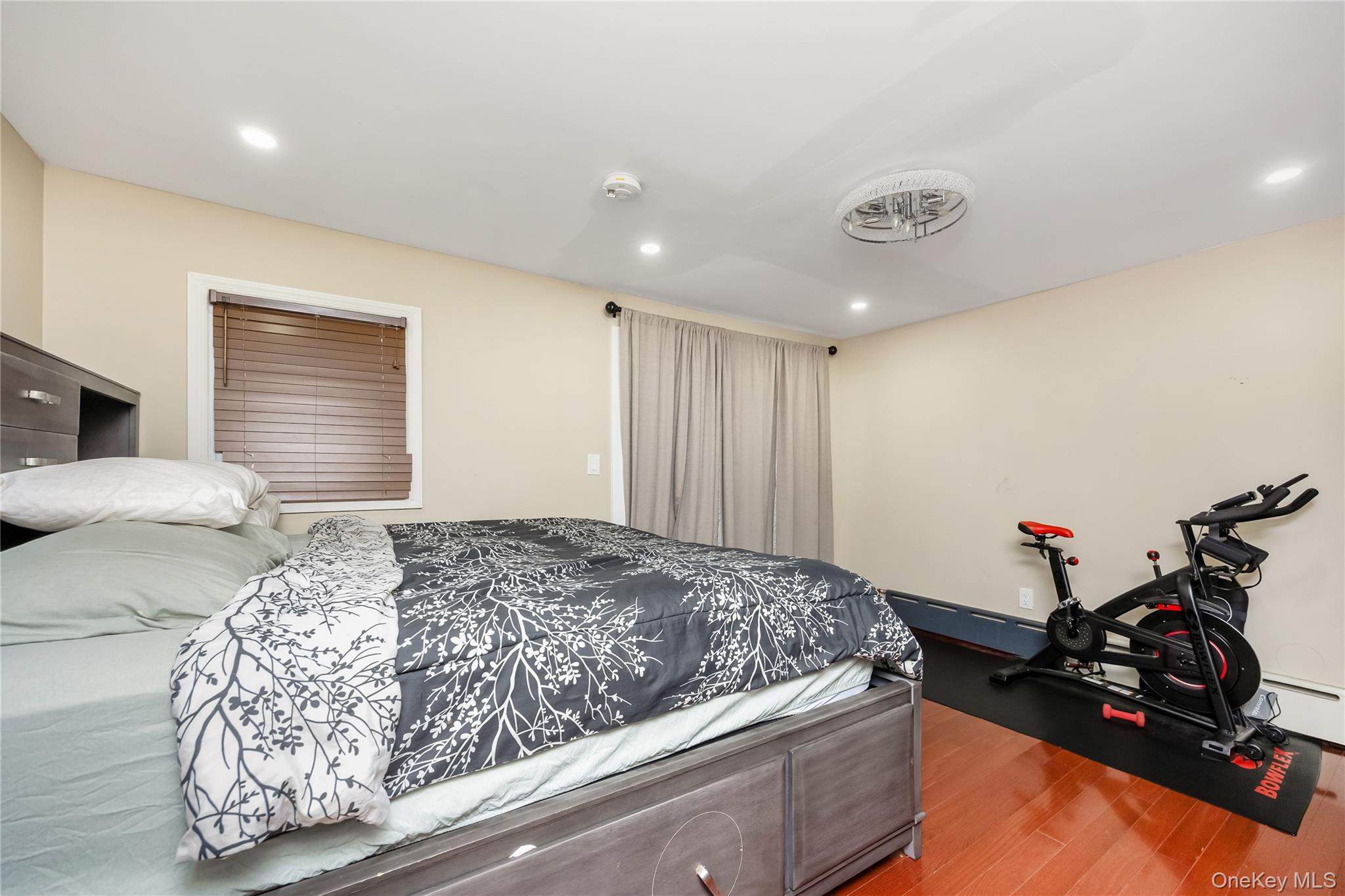 102-18 216th Street Queens, NY 11429 - Photo 12 of 23 a bedroom with a bed and wooden floor