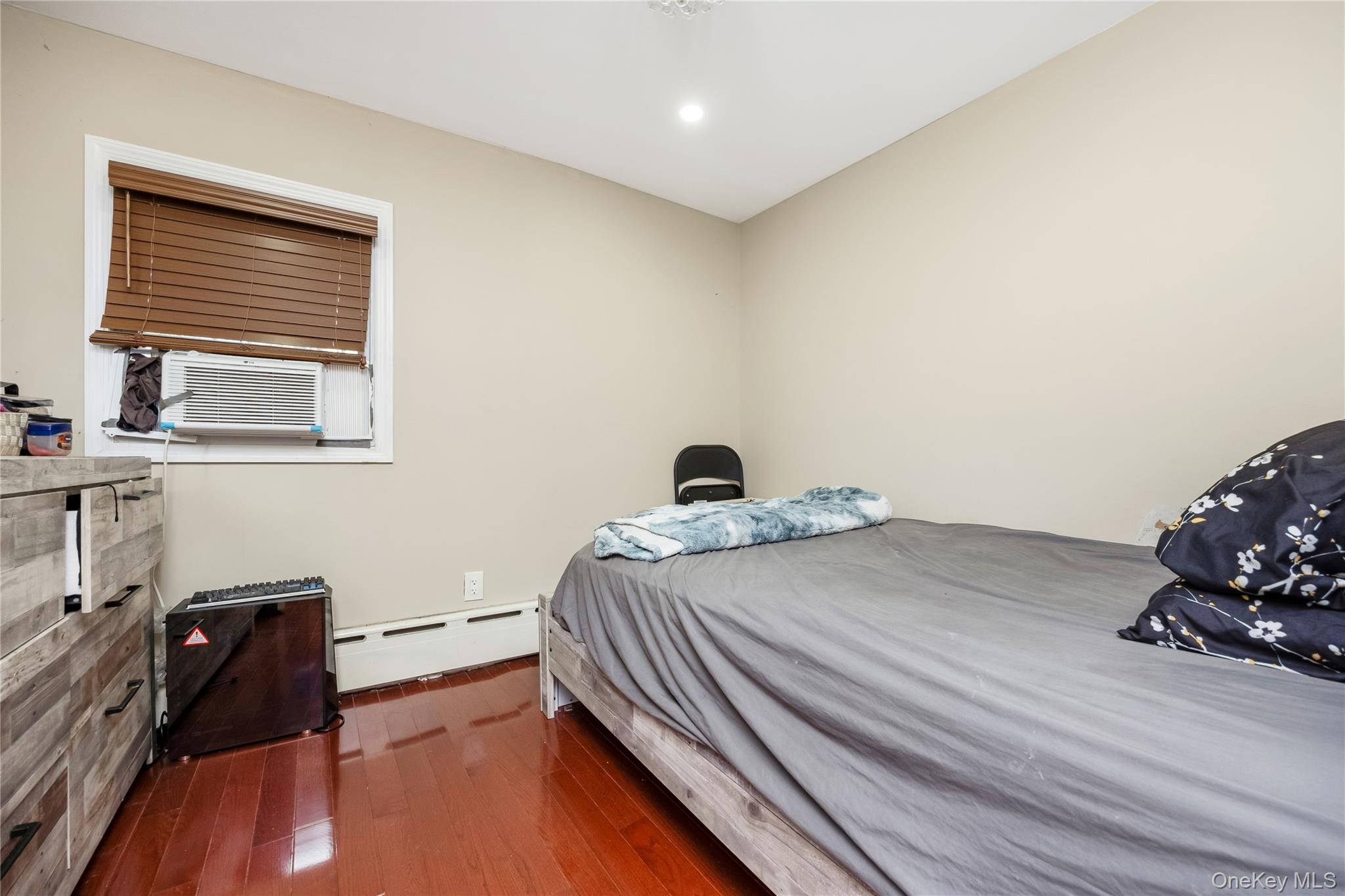 102-18 216th Street Queens, NY 11429 - Photo 13 of 23 a bedroom with a bed and wooden floor