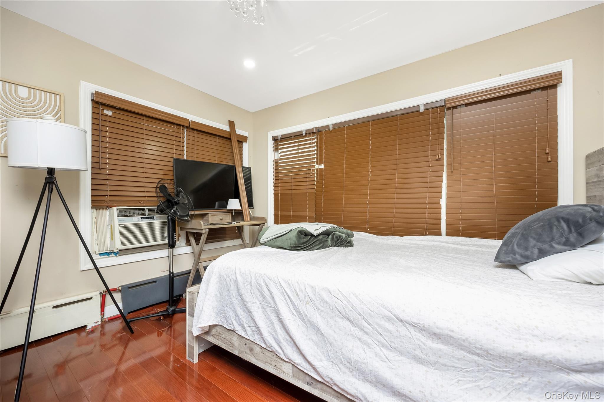 102-18 216th Street Queens, NY 11429 - Photo 14 of 23 a bedroom with a bed and wooden floor