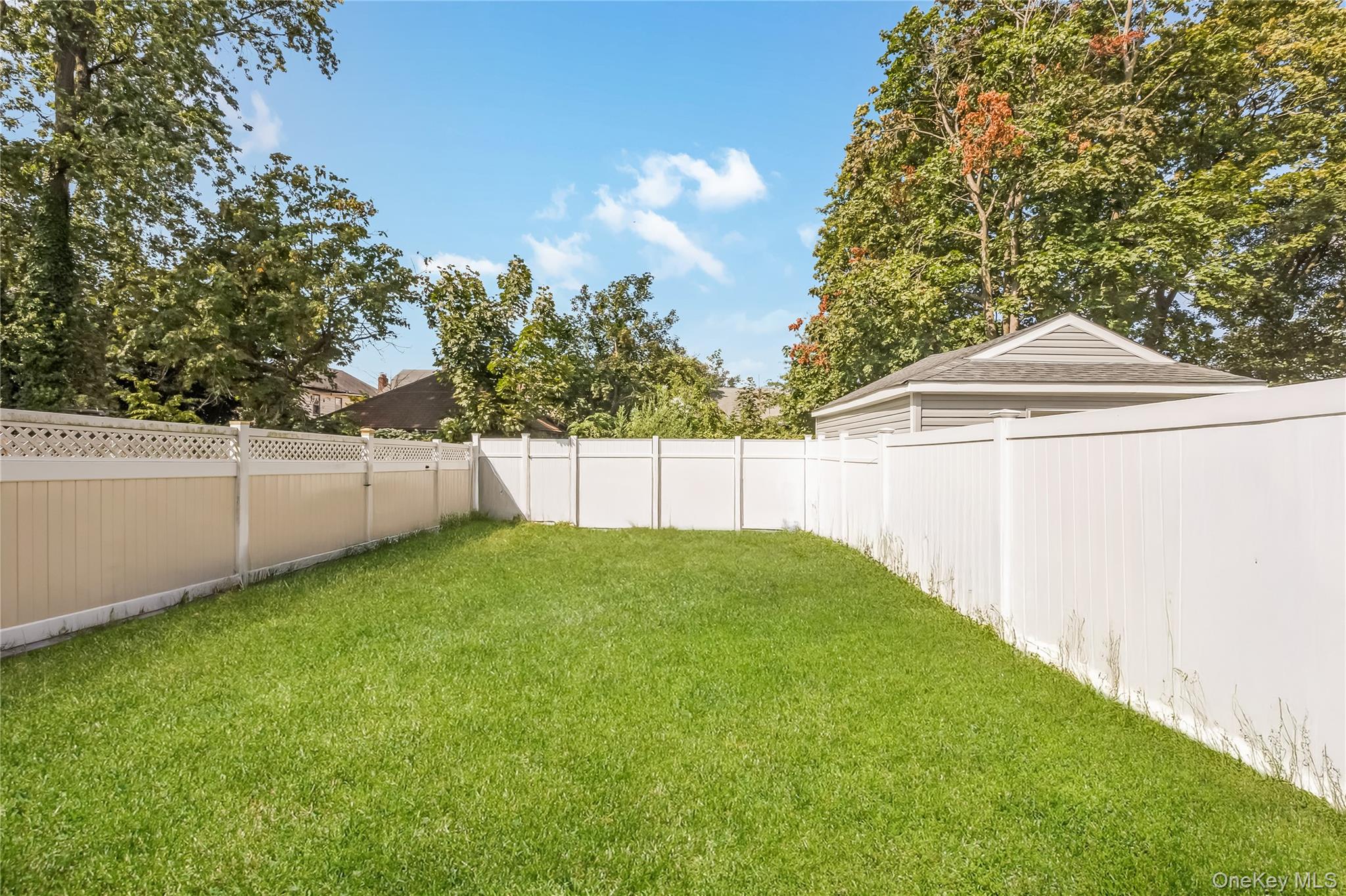 102-18 216th Street Queens, NY 11429 - Photo 19 of 23 a backyard of a house with lots of green space