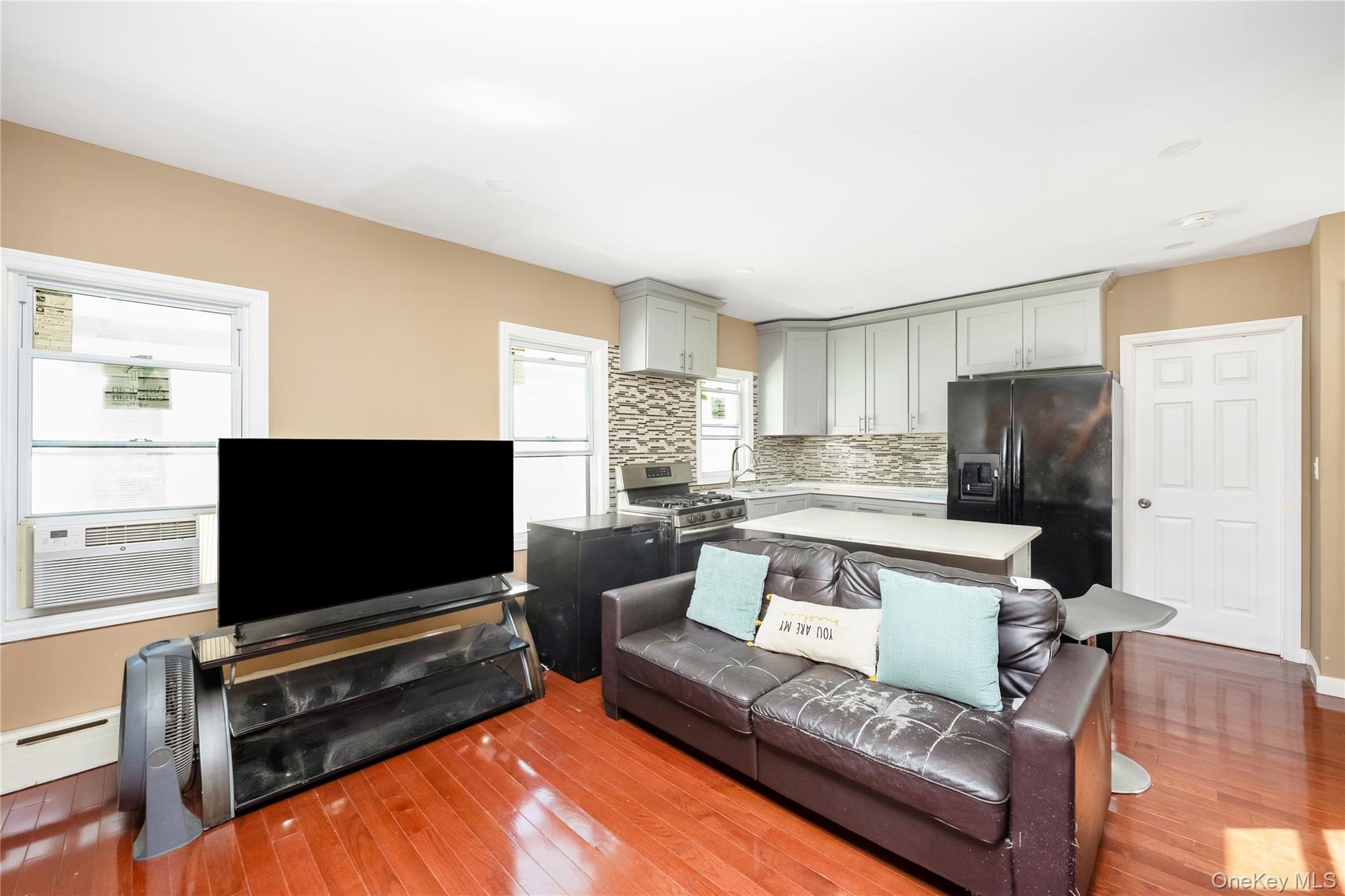 102-18 216th Street Queens, NY 11429 - Photo 6 of 23 a living room with furniture and a flat screen tv