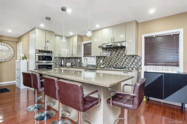 a kitchen with stainless steel appliances kitchen island granite countertop a sink and cabinets