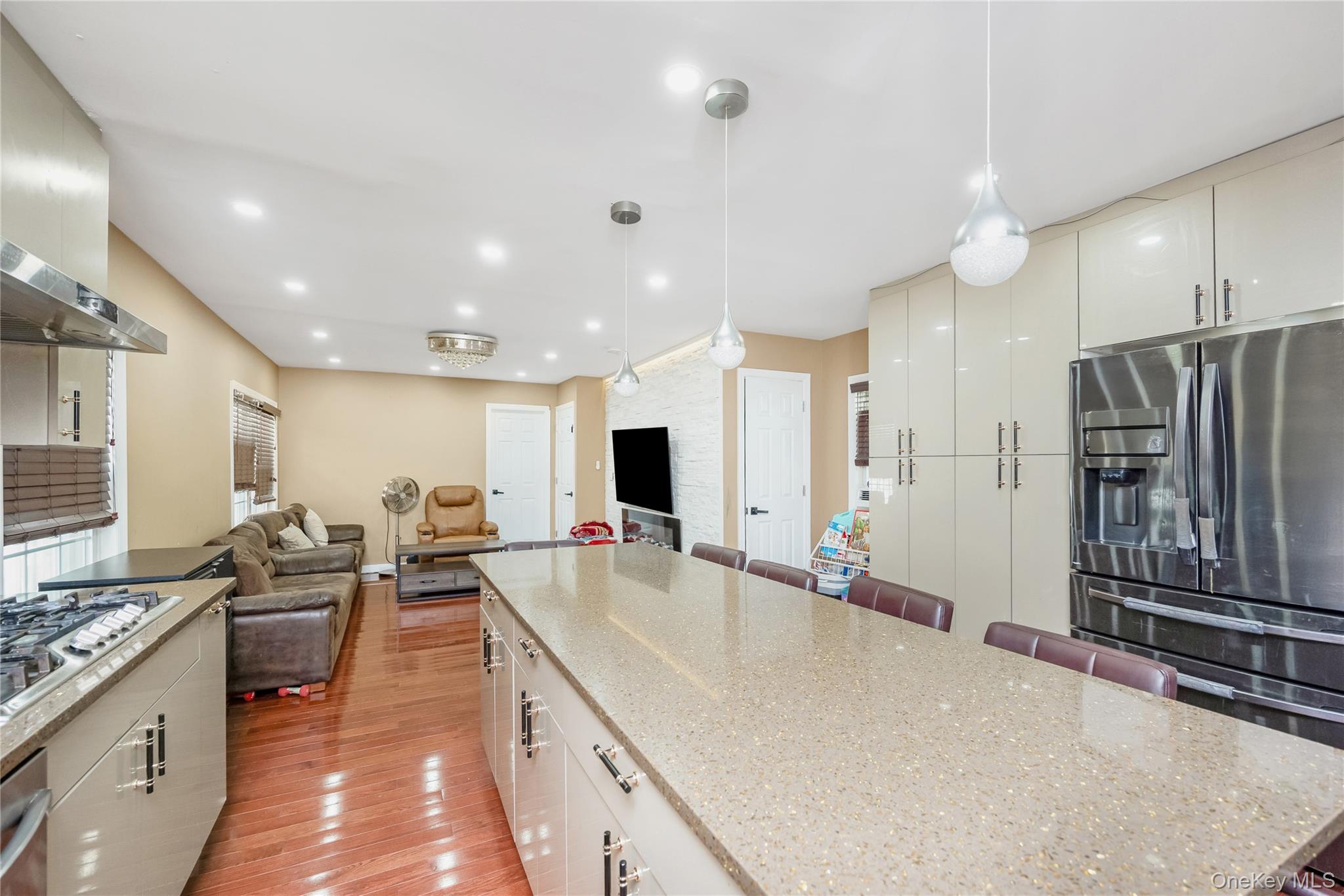 102-18 216th Street Queens, NY 11429 - Photo 21 of 23 a large kitchen with kitchen island a large counter top space a sink stainless steel appliances and cabinets